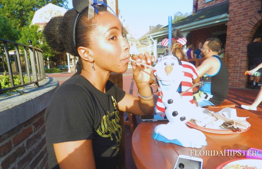 NikkyJ enjoying snack at Disney World. Keep reading to get the best snacks to take to Disney World.