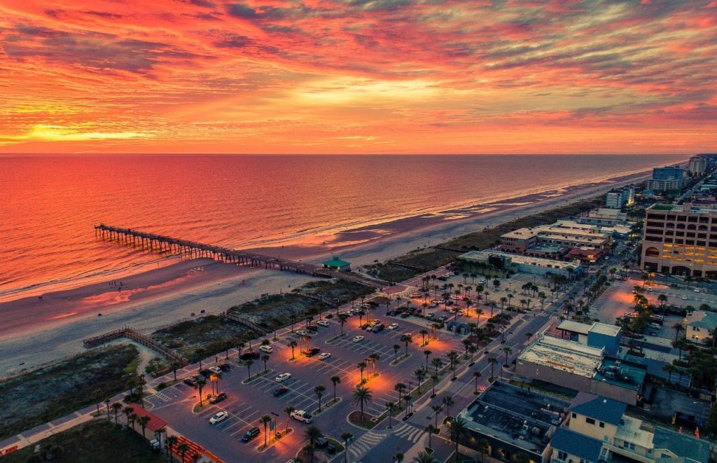A sunrise, aerial view of Jacksonville Beach, Florida. Keep reading for more places to take a perfect day trip from Orlando, Florida. 