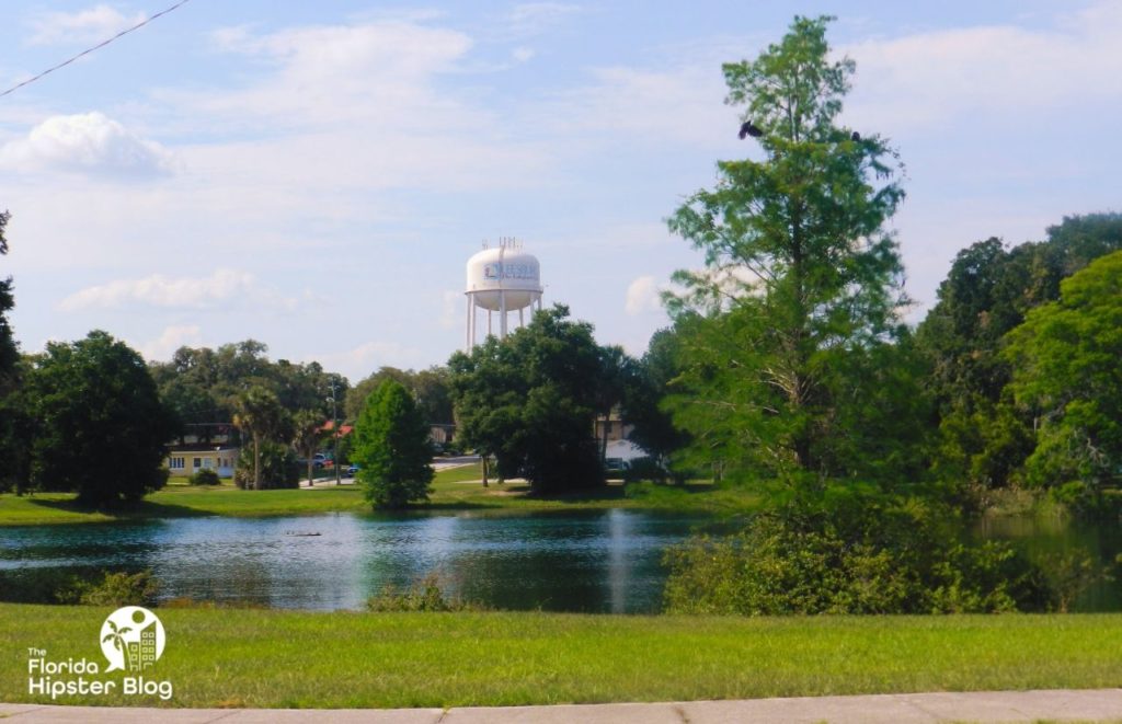 Welcome to Leesburg, Florida Water Tower over Pond. Keep reading to discover more of the best Florida day trips from The Villages, Florida. 