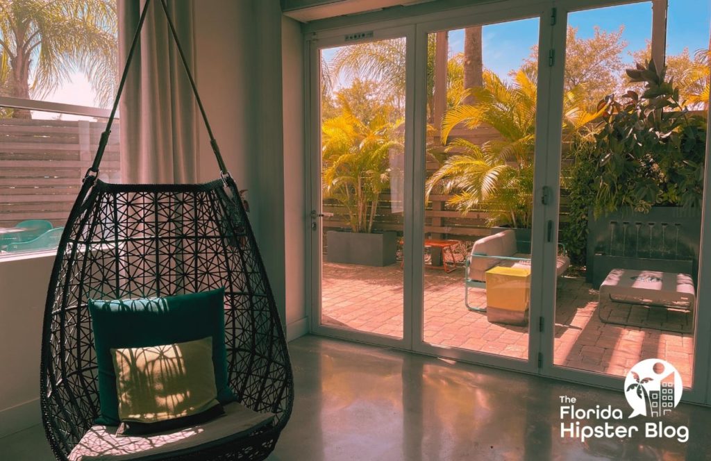 Peaceful sitting area with a hanging chair in Tampa Bay, Florida Hotel Alba. Keep reading for your full guide to one of the best hotels in Tampa, Hotel Alba Tampa, Tapestry Collection by Hilton. 