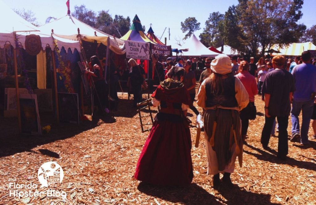 Renaissance Fair Festival with people in costumes and vendors. Keep reading to find out all you need to know about visiting Florida in March.