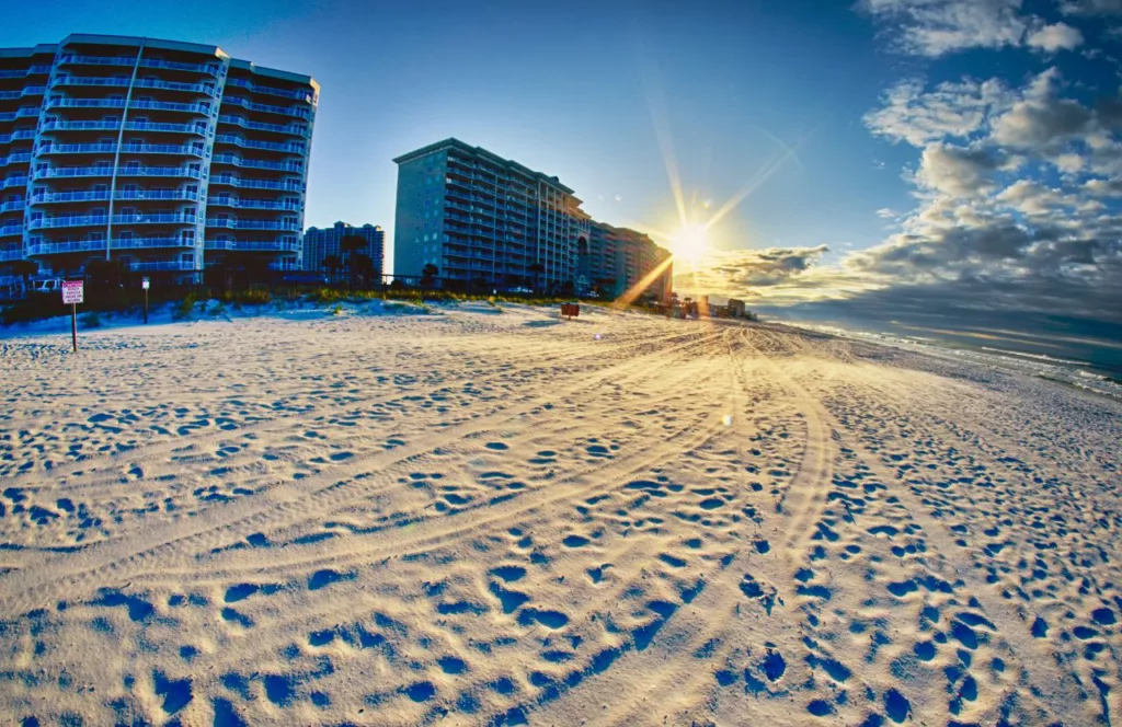 Keep reading to learn about the best things to do in the Florida Panhandle. Destin, Florida with white sands and hotels at sunrise.