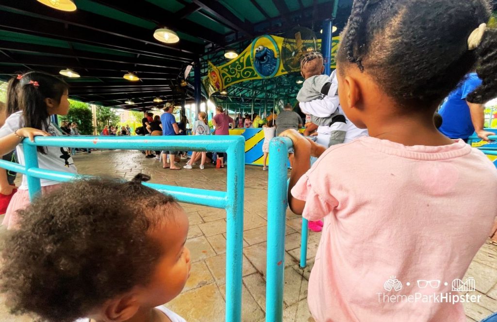 SeaWorld Orlando Resort Christmas Celebration Sesame Street Land Carousel with black girls. Keep reading to learn more about SeaWorld Orlando Sesame Street Land.